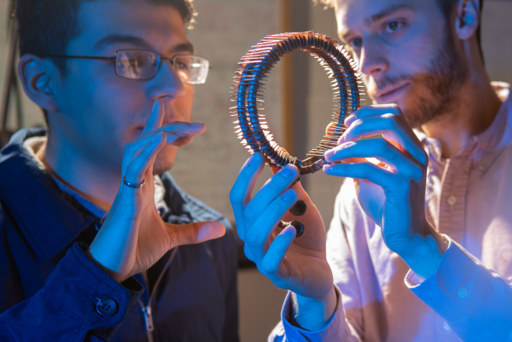 SVL students Herrera (left) and Callanan (right) discuss a miniature ThermoAcoustic device